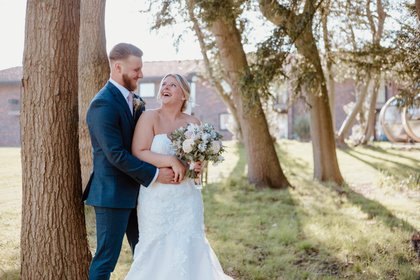 bride and groom smiling to each other at Denham Grove Hotel in Uxbridge