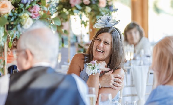 Wedding guest laughing at wedding brocket hall wedding photography Hertfordshire