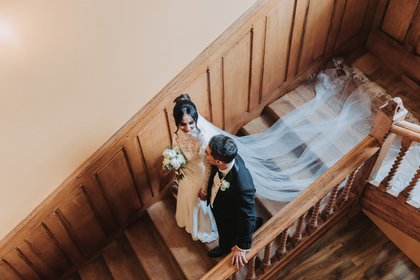 Bride and groom walking down the stairs at Stevenage Orthodox Church wedding photographer