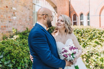 Bride and groom smiling at eachother at st albans registry office wedding photographer